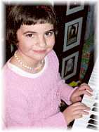 Photo of little girl playing piano